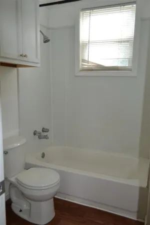 a bathroom with a toilet a sink and a bathtub
