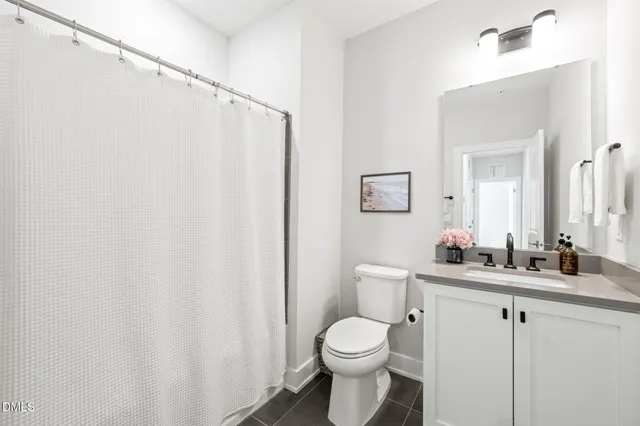 a bathroom with a toilet a sink and a mirror