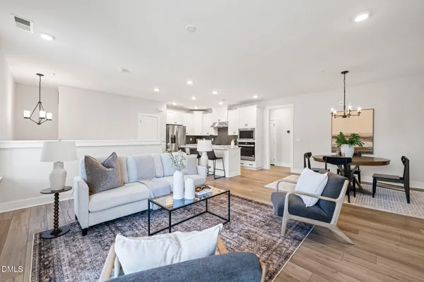 a living room with furniture and kitchen view
