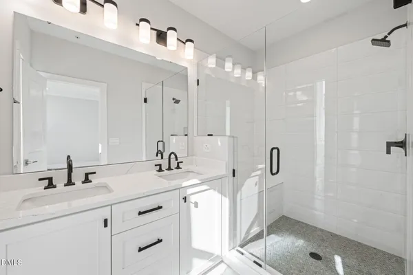 a bathroom with a double vanity sink mirror and double