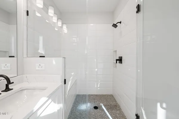 a bathroom with a tub sink and mirror