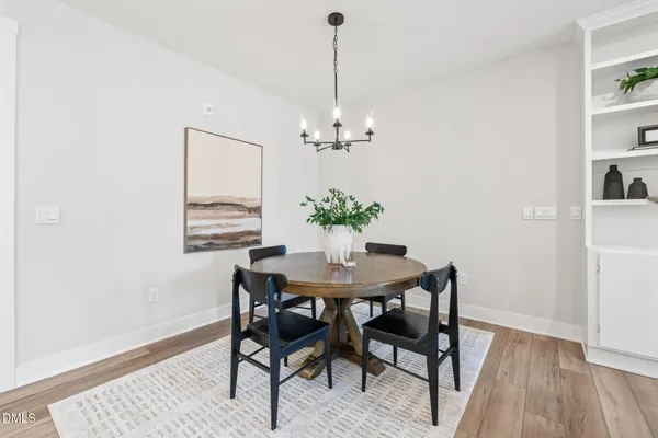 a dining room with furniture and chandelier