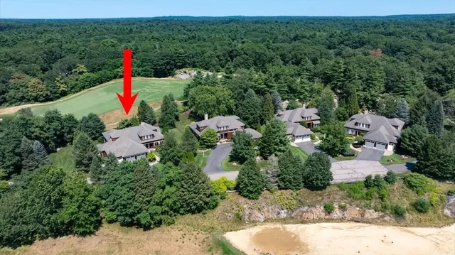 an aerial view of residential house with outdoor space and trees all around