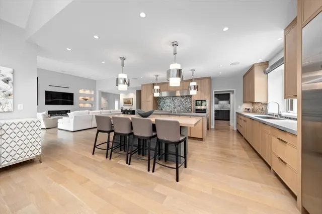 a large kitchen with a table and chairs