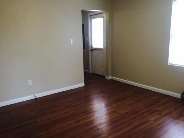 10153 Goodview Road Goodview, VA 24095 - Photo 6 of 15 an empty room with wooden floor and windows