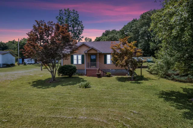 a front view of a house with a yard