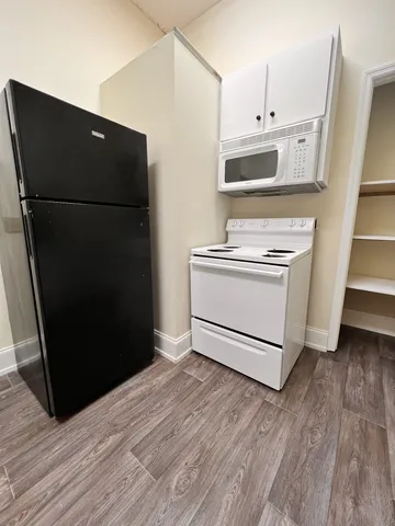 a kitchen with a refrigerator and a stove