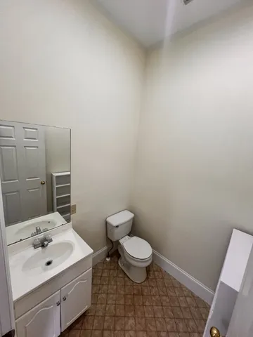 a bathroom with a sink a toilet and a mirror
