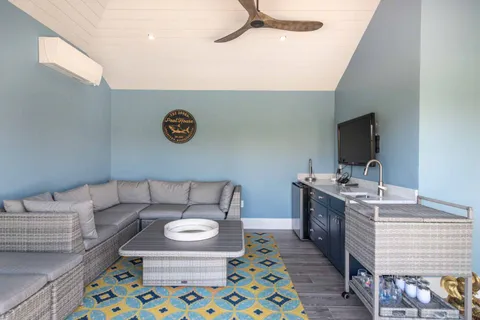 a living room with a couch and a stove with a dining table