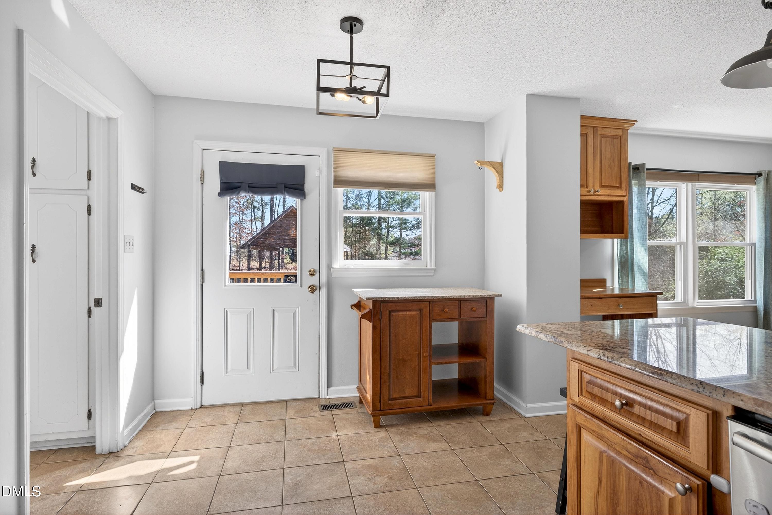 810 Woodland Road Creedmoor, NC 27522 - Photo 16 of 77 a view of kitchen with granite countertop cabinets and window