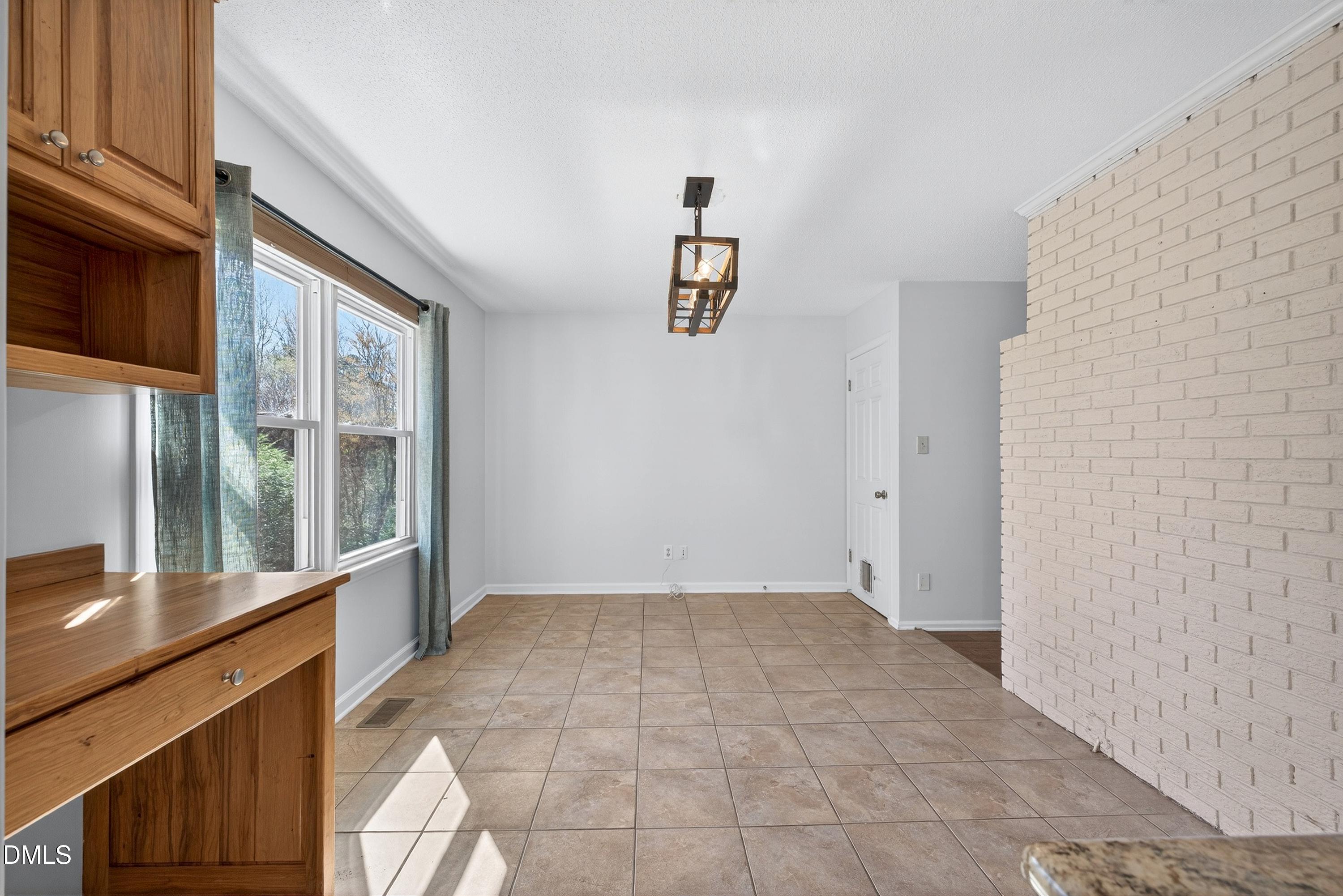 810 Woodland Road Creedmoor, NC 27522 - Photo 20 of 77 a view of an empty room with a window
