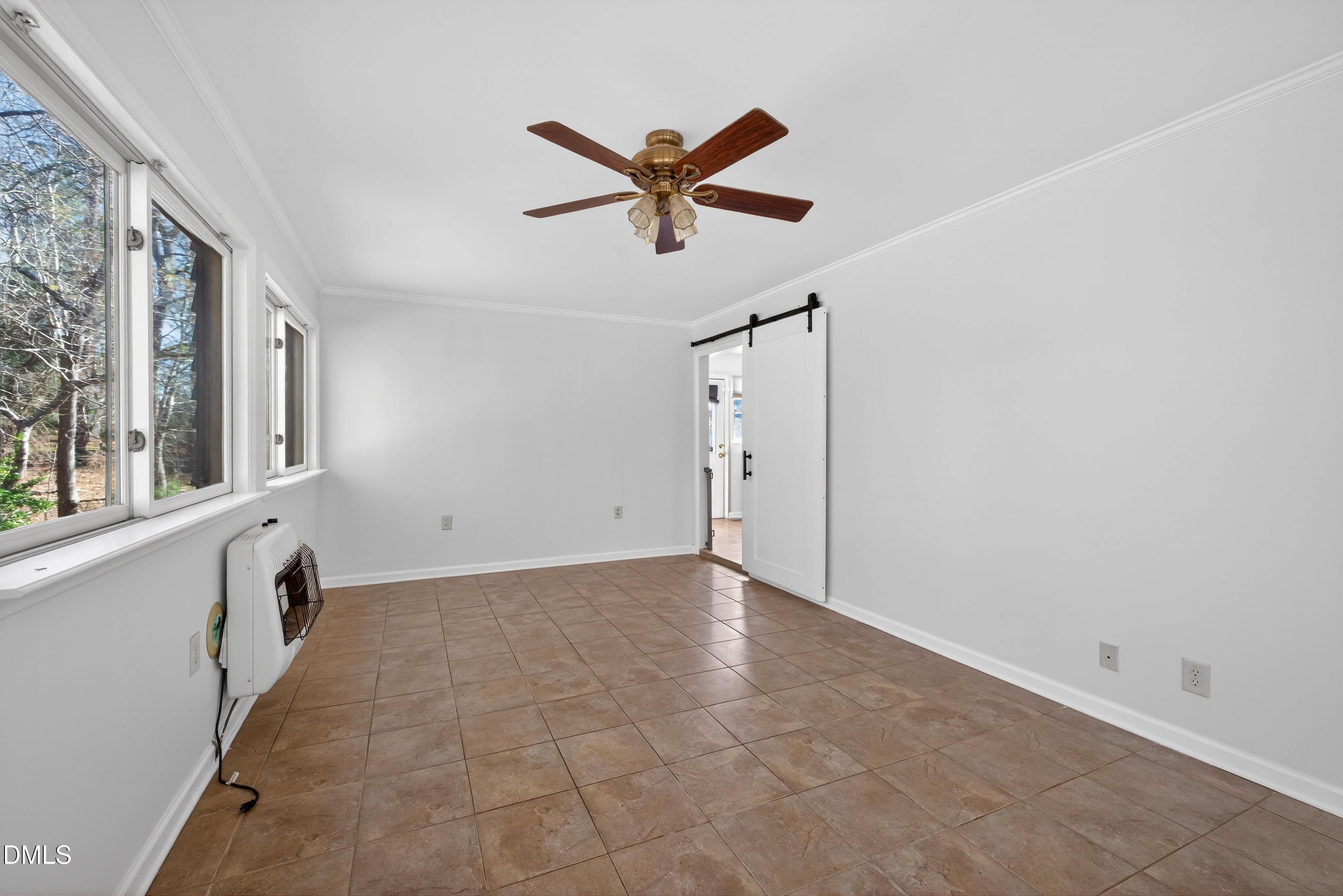 810 Woodland Road Creedmoor, NC 27522 - Photo 25 of 77 a view of a livingroom with a ceiling fan and window