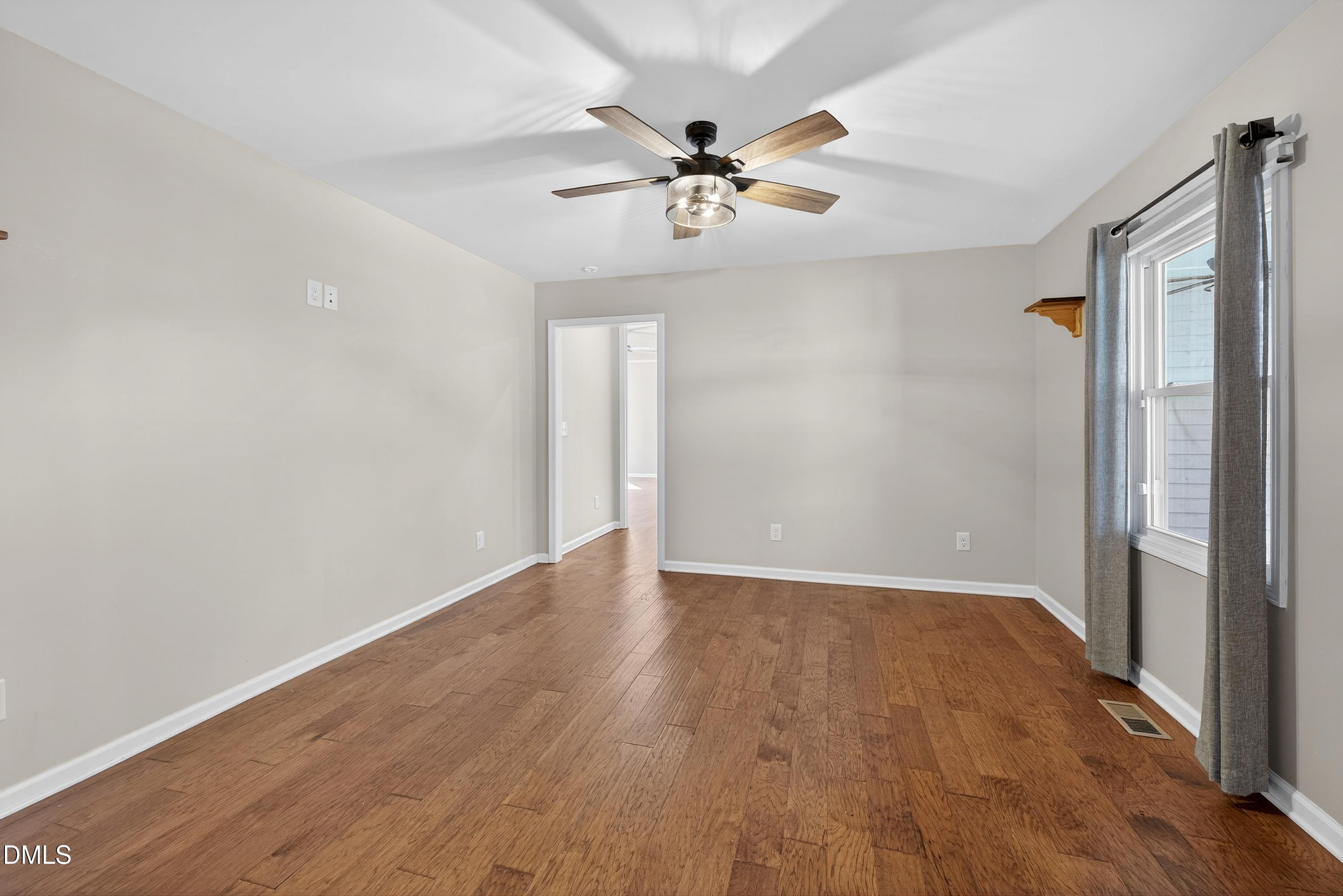 810 Woodland Road Creedmoor, NC 27522 - Photo 28 of 77 a view of an empty room with wooden floor