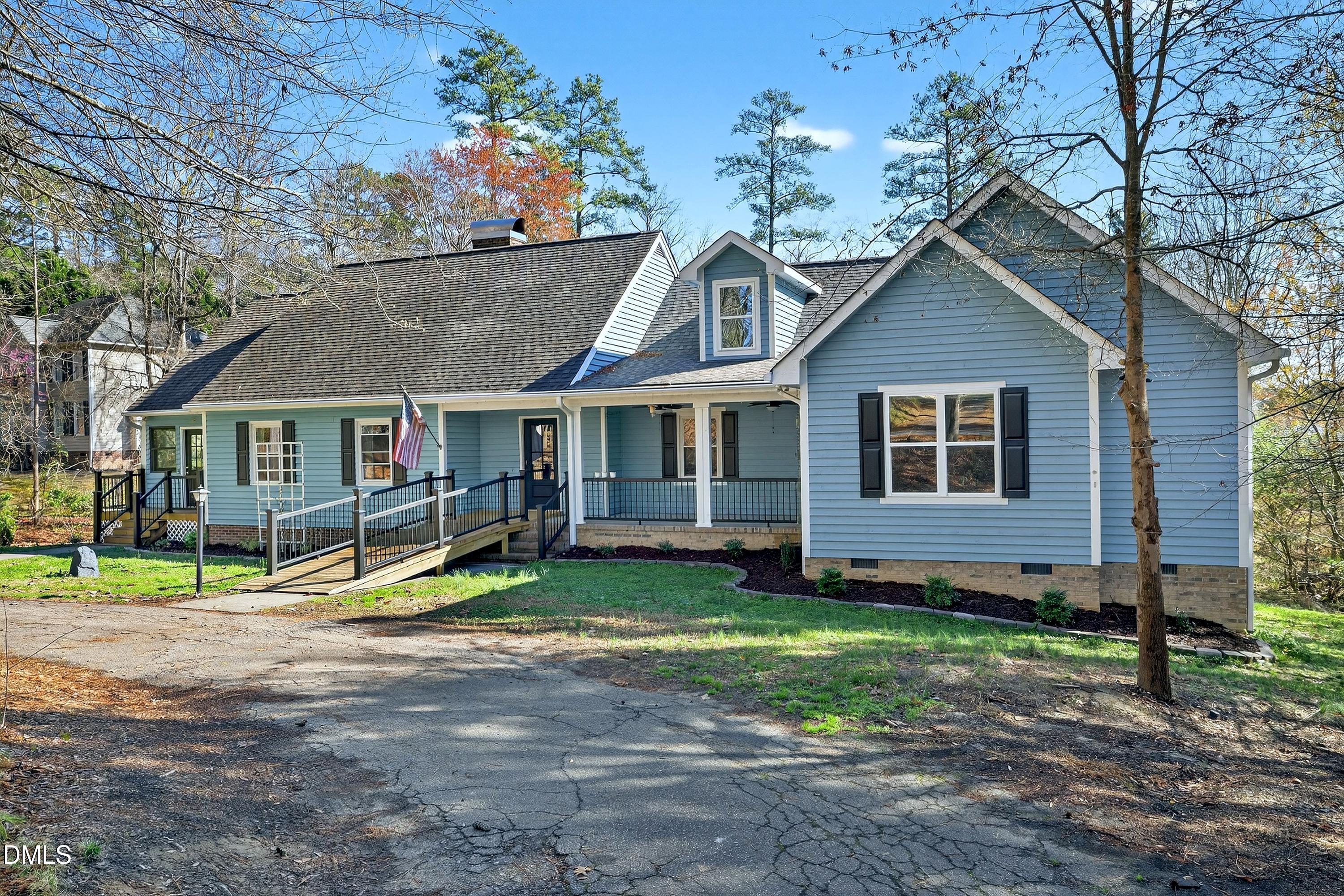 810 Woodland Road Creedmoor, NC 27522 - Photo 3 of 77 a view of a house with a yard and large tree