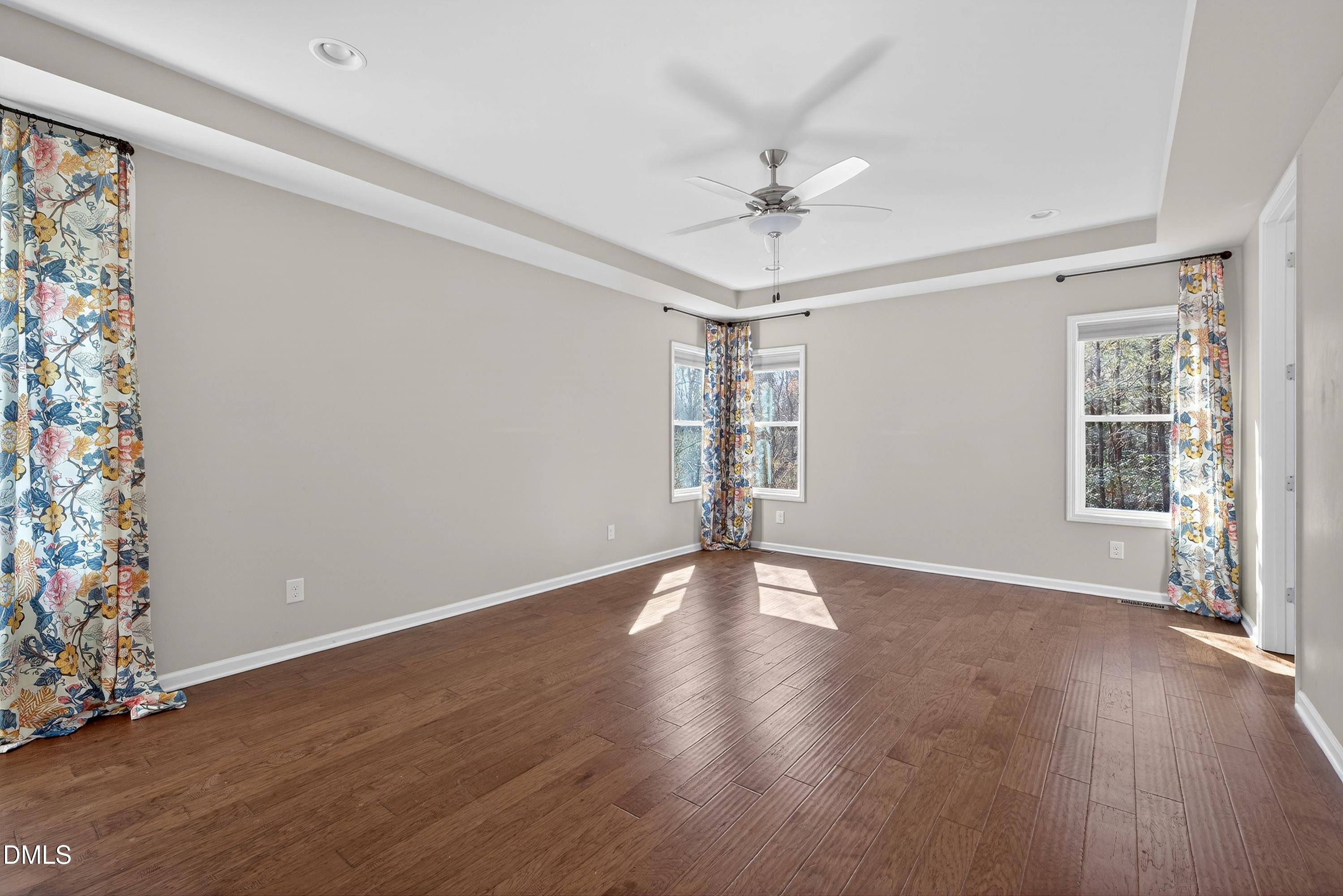 810 Woodland Road Creedmoor, NC 27522 - Photo 32 of 77 a view of an empty room with wooden floor and a window