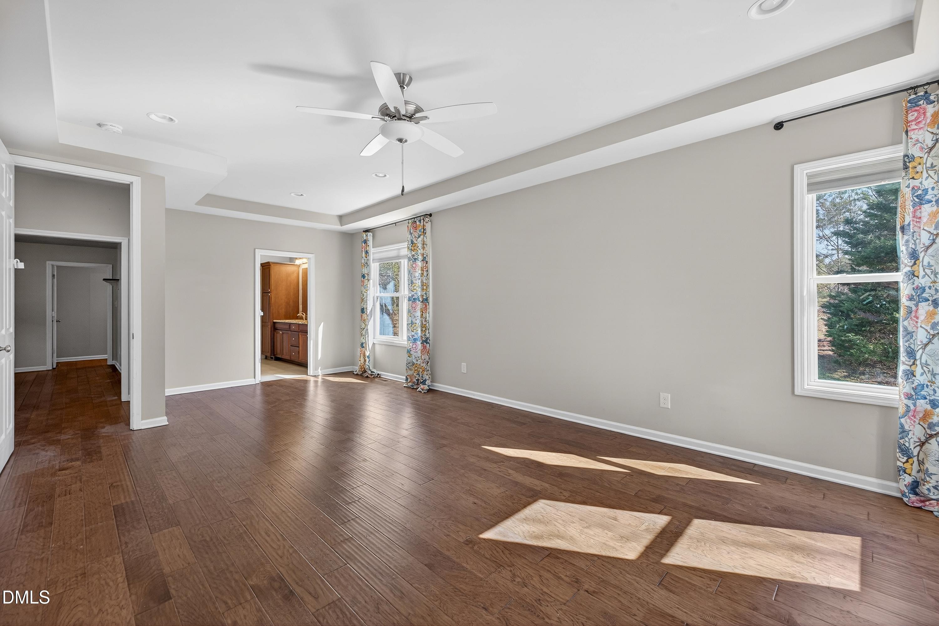 810 Woodland Road Creedmoor, NC 27522 - Photo 33 of 77 a view of an empty room with wooden floor and a window