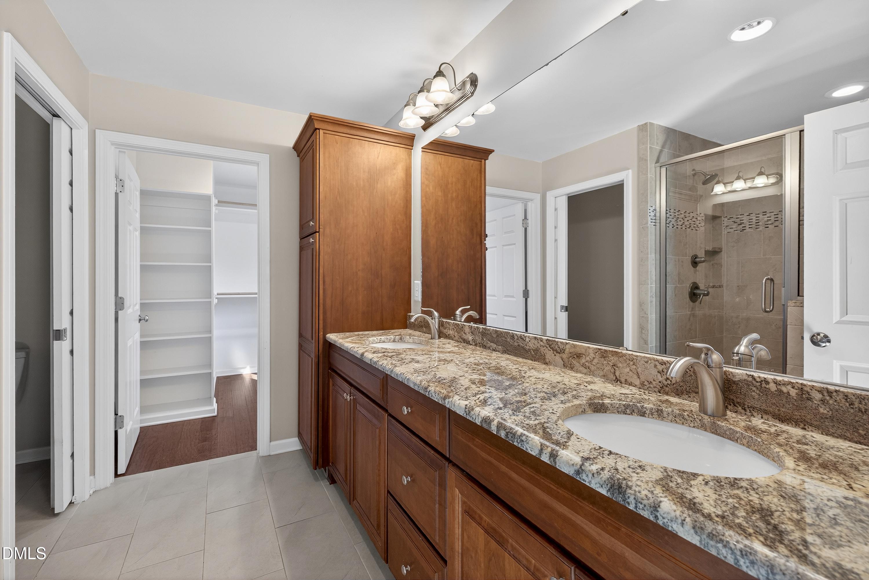 810 Woodland Road Creedmoor, NC 27522 - Photo 35 of 77 a bathroom with a granite countertop sink and a mirror