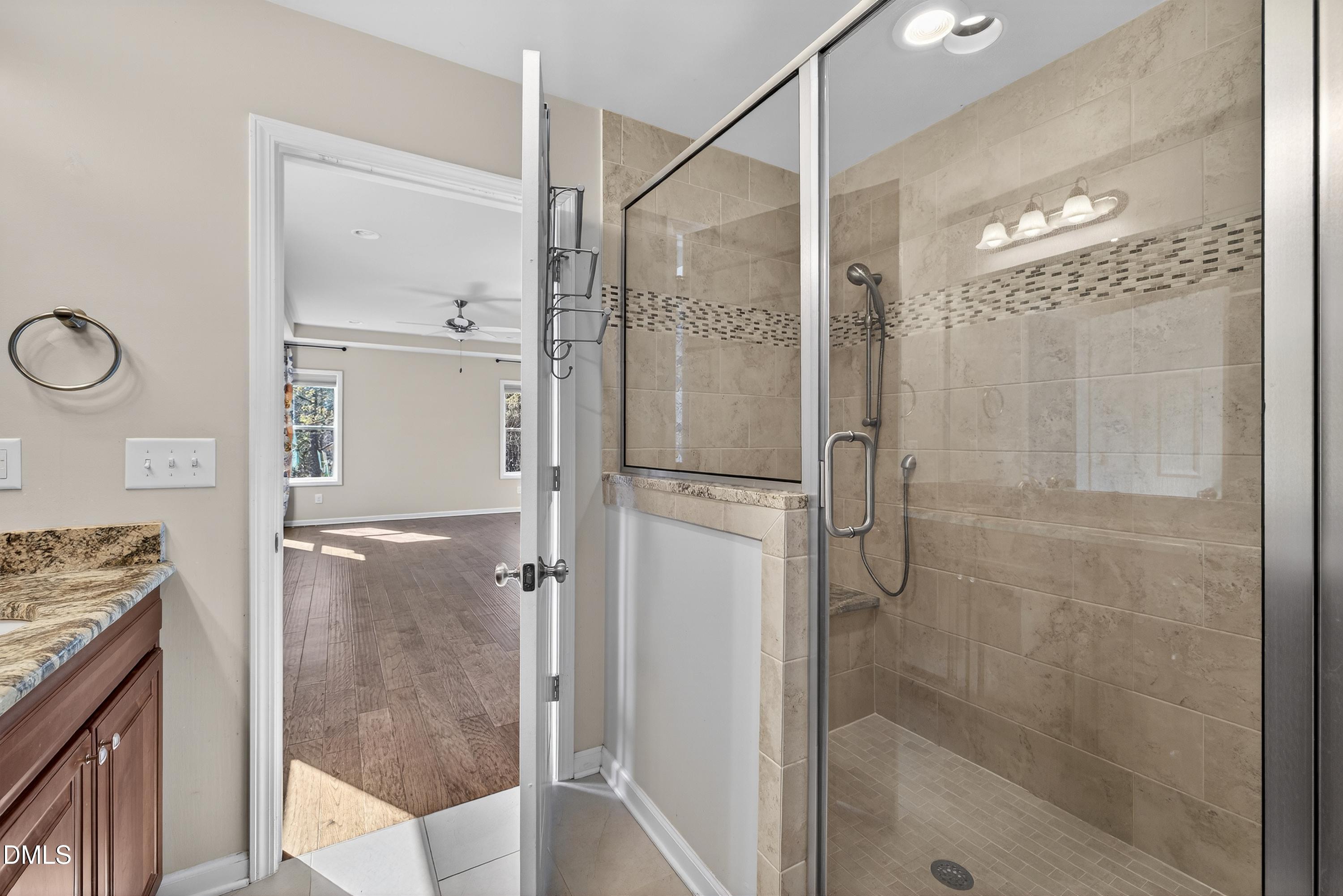 810 Woodland Road Creedmoor, NC 27522 - Photo 36 of 77 a bathroom with a shower and a mirror