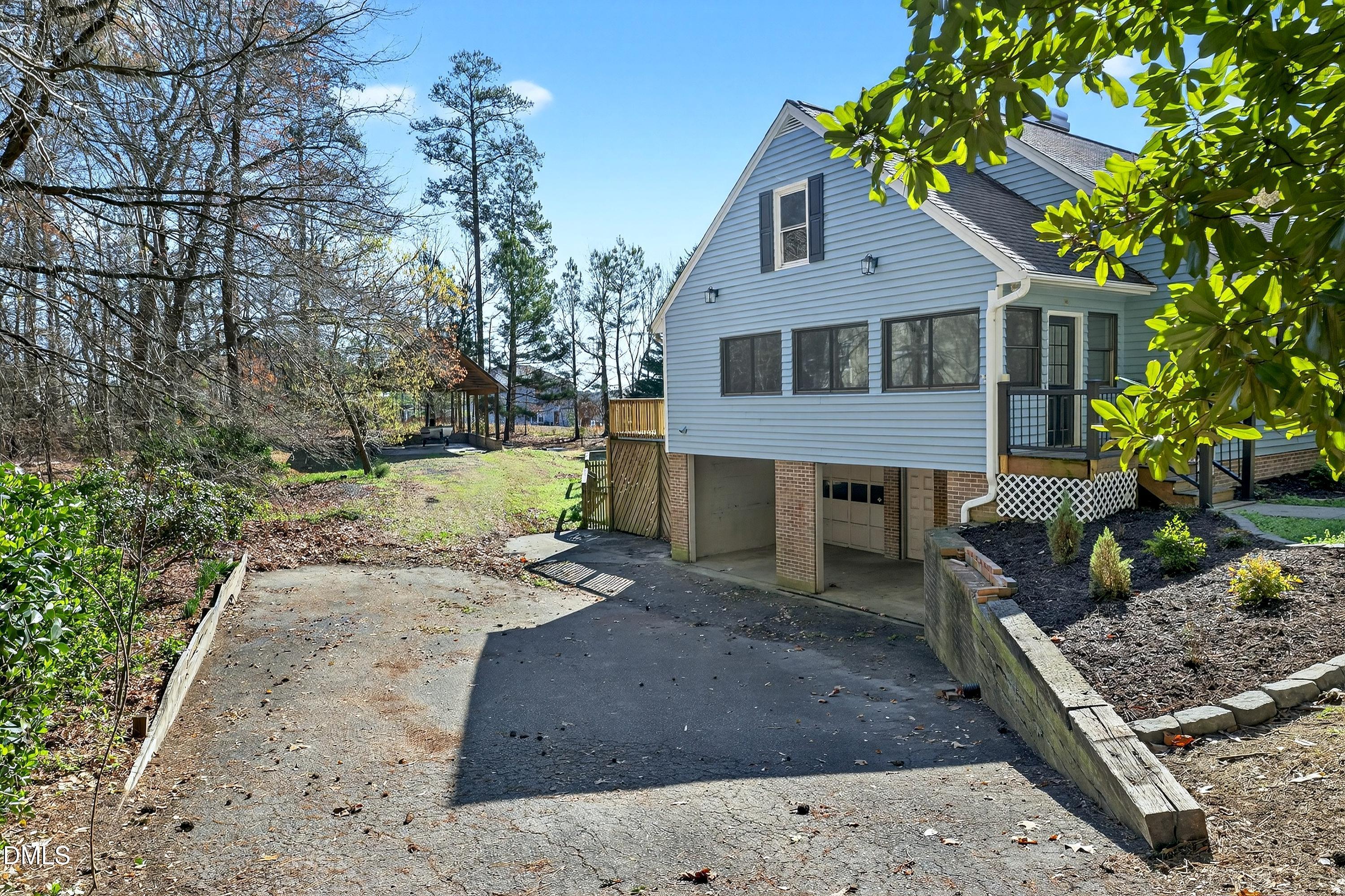 810 Woodland Road Creedmoor, NC 27522 - Photo 55 of 77 a front view of a house with a yard and garage
