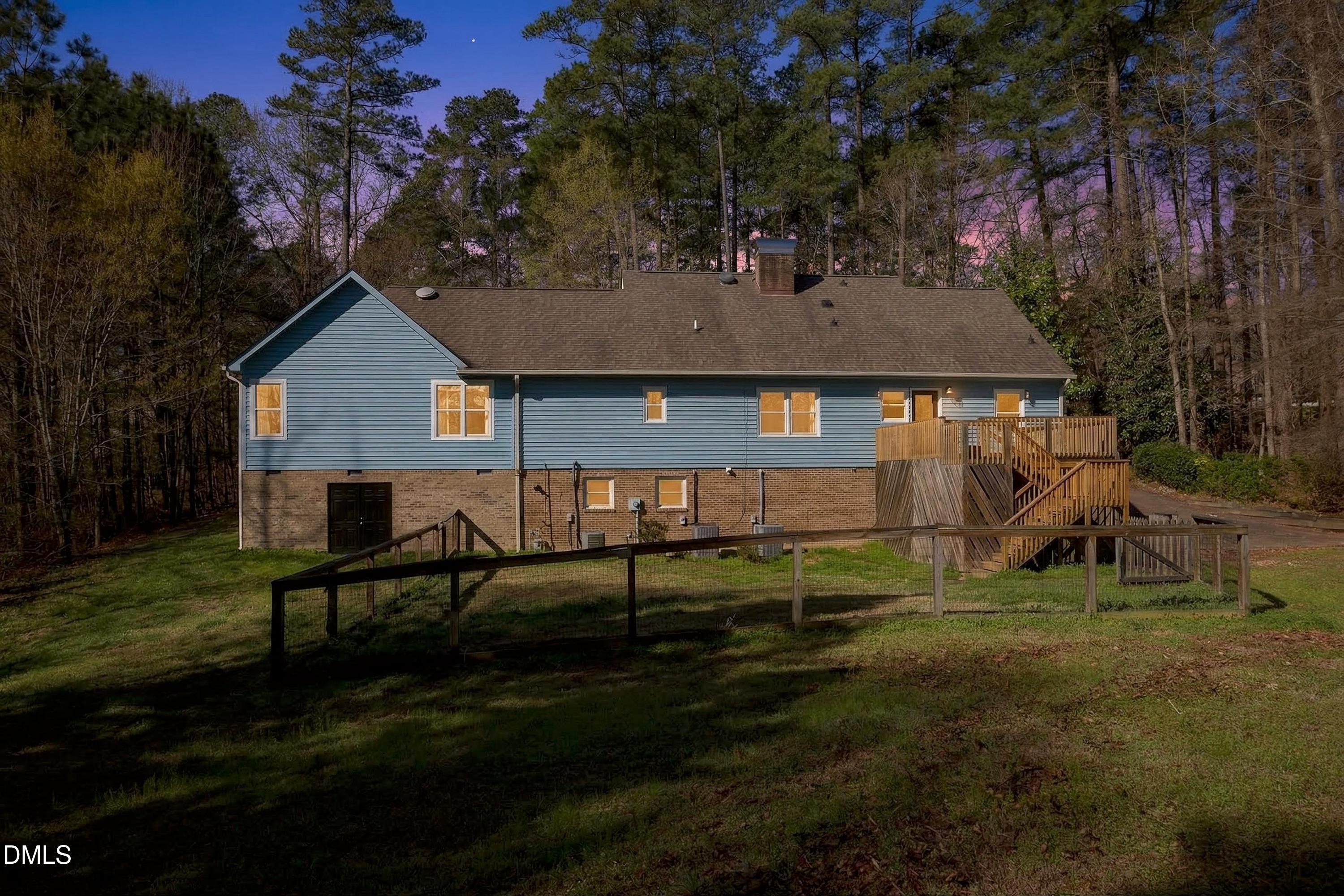 810 Woodland Road Creedmoor, NC 27522 - Photo 58 of 77 a view of a house with backyard and a tree