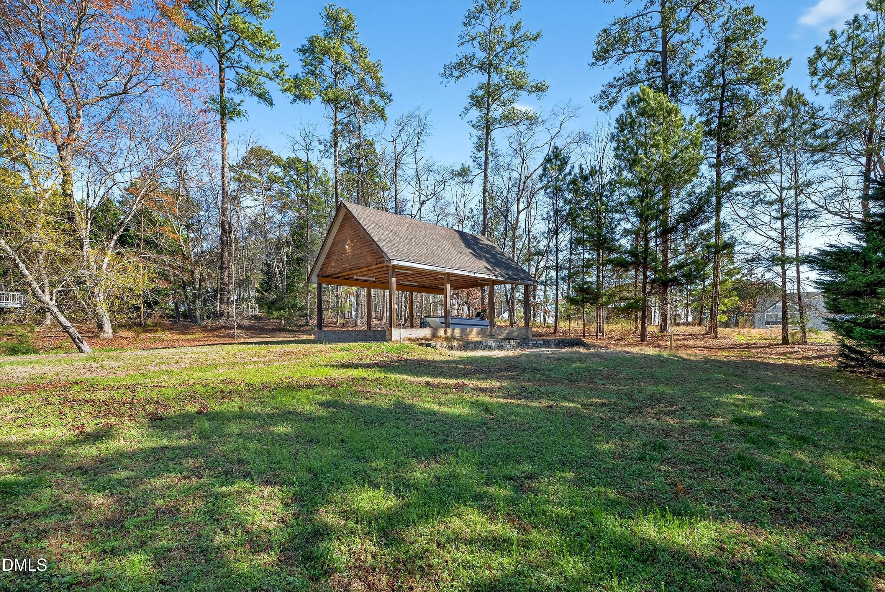 810 Woodland Road Creedmoor, NC 27522 - Photo 63 of 77 a backyard of a house with table and chairs