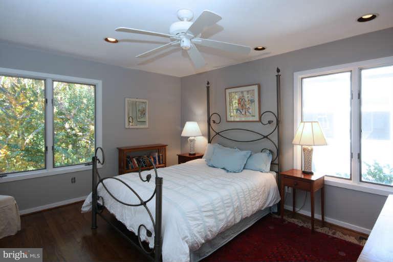 525 Clear Spring Road Great Falls, VA 22066 - Photo 17 of 30 a bedroom with a bed window and a table in it