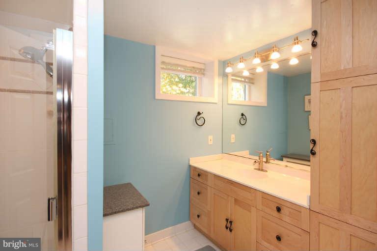 525 Clear Spring Road Great Falls, VA 22066 - Photo 22 of 30 a bathroom with a sink double vanity and a mirror