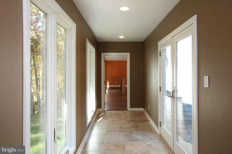 525 Clear Spring Road Great Falls, VA 22066 - Photo 23 of 30 a view of a hallway with wooden floor and windows