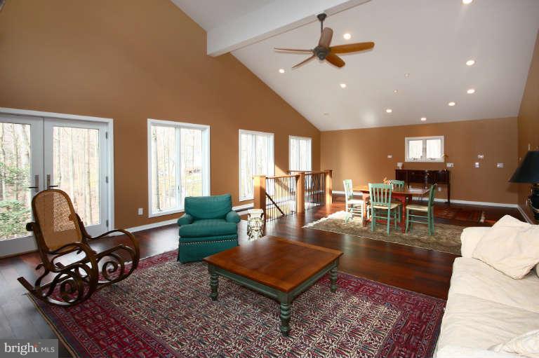 525 Clear Spring Road Great Falls, VA 22066 - Photo 24 of 30 a living room with furniture a rug and a chandelier