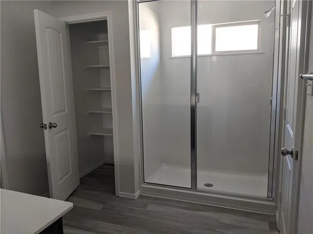 a bathroom with a glass shower door