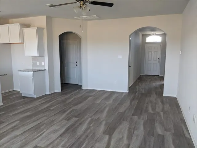 a view of a room with wooden floor and a sink