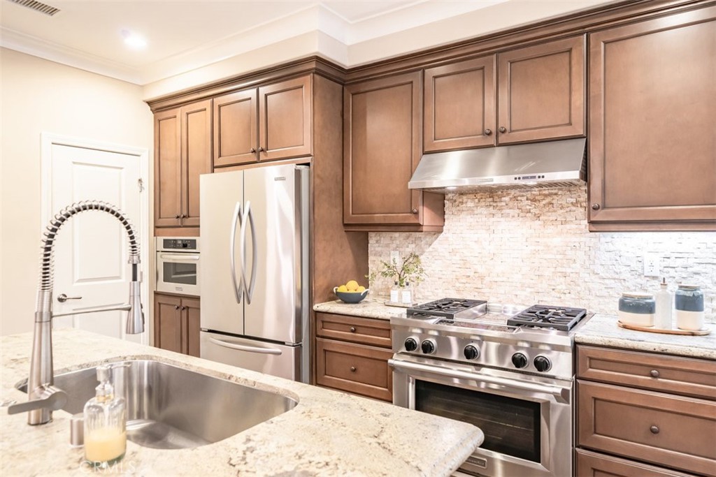 43 Lupari Irvine, CA 92618 - Photo 15 of 68 a kitchen with a stove a sink and a refrigerator