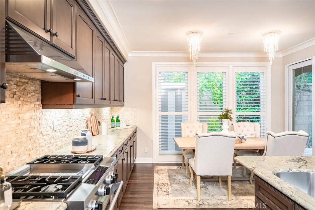 43 Lupari Irvine, CA 92618 - Photo 23 of 68 a kitchen with a stove a sink and a dining table