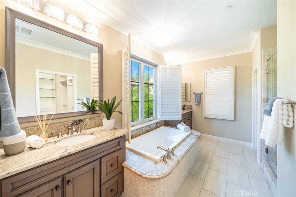 43 Lupari Irvine, CA 92618 - Photo 43 of 68 a spacious bathroom with a granite countertop sink and a mirror