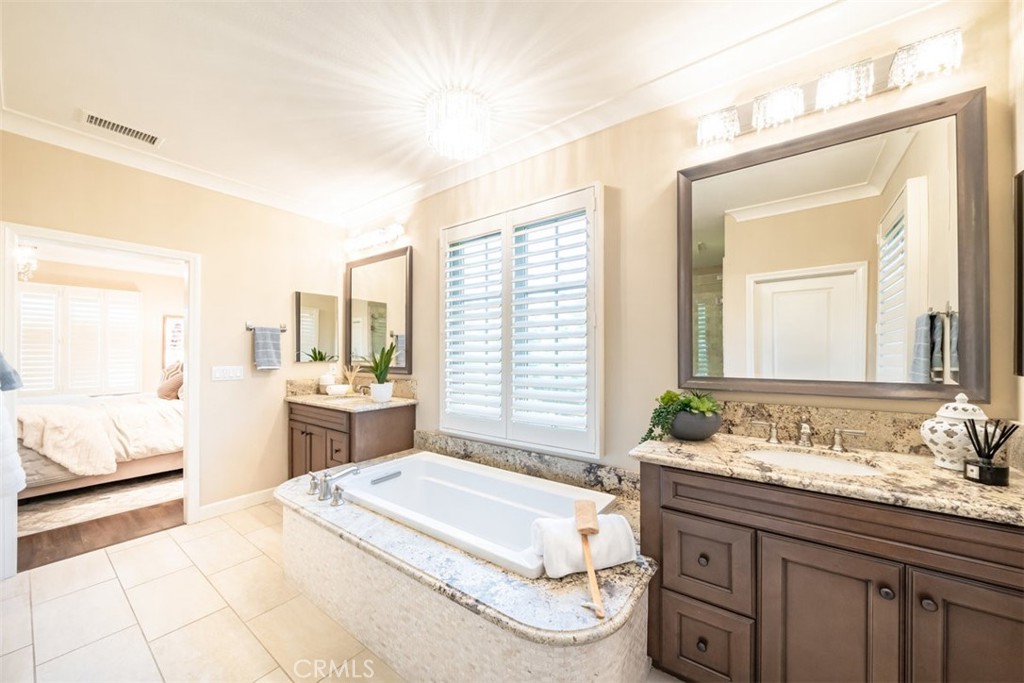 43 Lupari Irvine, CA 92618 - Photo 47 of 68 a spacious bathroom with a granite countertop tub sink and mirror