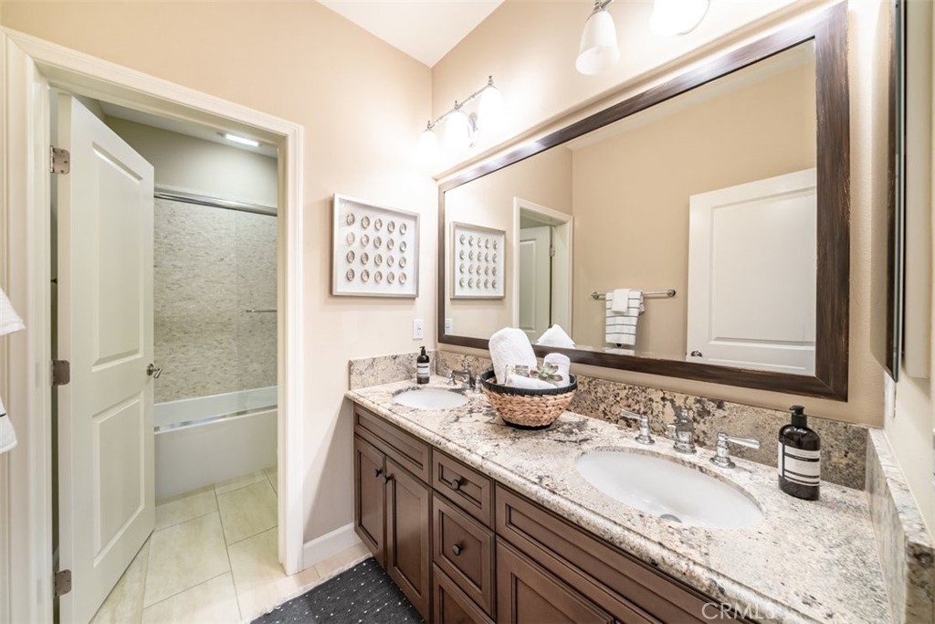43 Lupari Irvine, CA 92618 - Photo 51 of 68 a bathroom with a granite countertop sink mirror and double