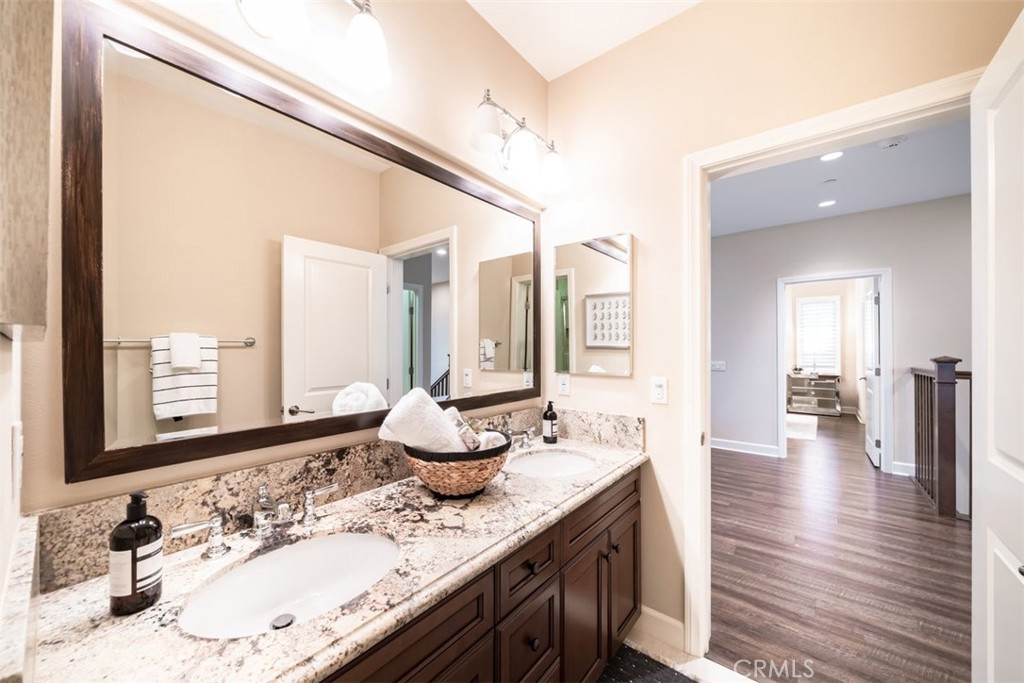 43 Lupari Irvine, CA 92618 - Photo 53 of 68 a bathroom with a granite countertop sink and a large mirror