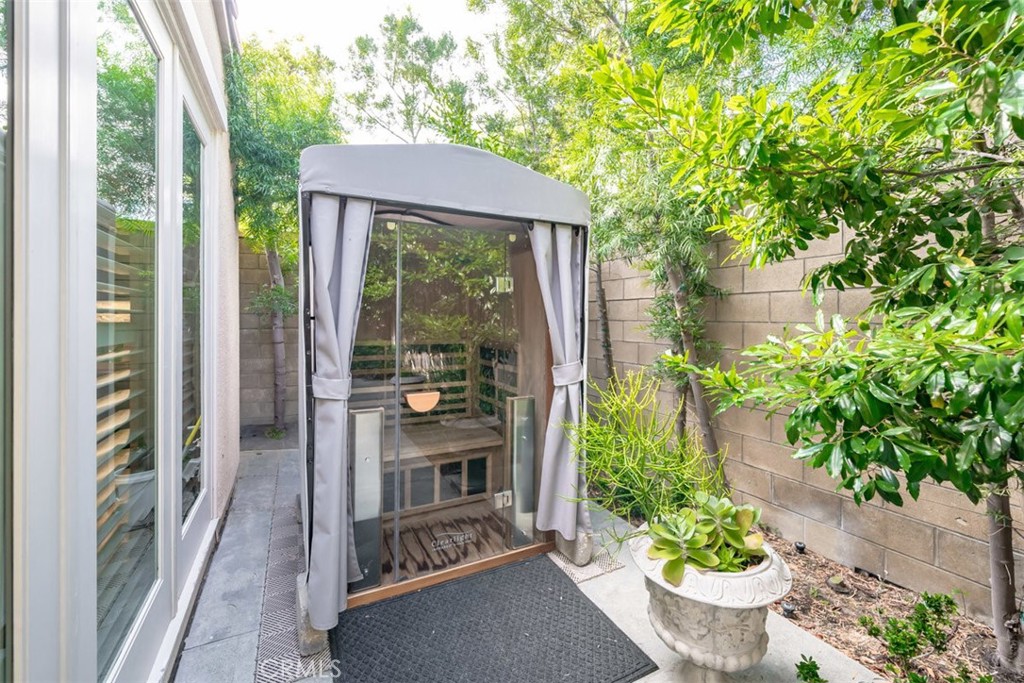 43 Lupari Irvine, CA 92618 - Photo 60 of 68 a front view of a house with a yard potted plants and large tree