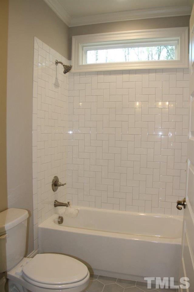1700 River Bend Lane Raleigh, NC 27610 - Photo 14 of 30 a bathroom with a toilet and a bathtub