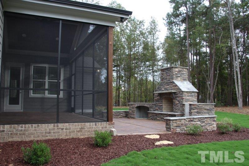 1700 River Bend Lane Raleigh, NC 27610 - Photo 22 of 30 a view of a back yard of the house with a bench
