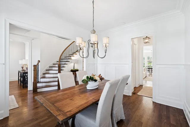 a living room with furniture kitchen view and a chandelier