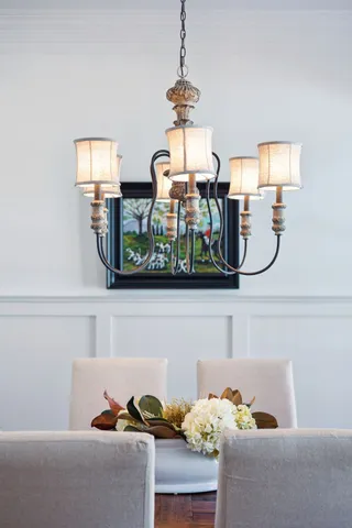 a living room with furniture and a chandelier