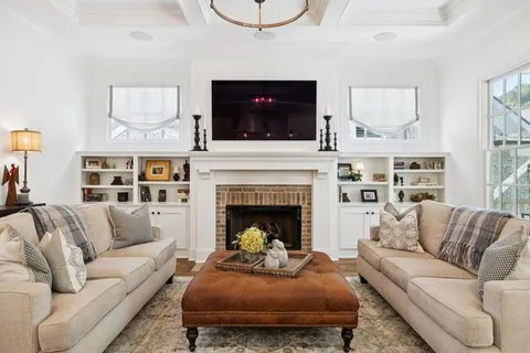 a bedroom with a bed and dresser with mirror