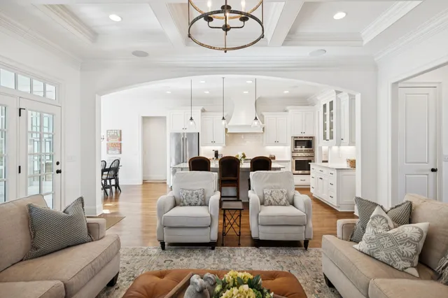 a living room with furniture a large window and a rug