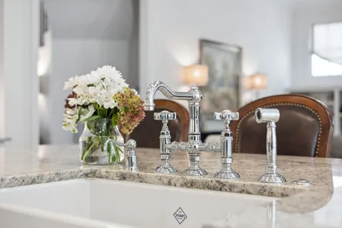 a living room with furniture a fireplace and a floor to ceiling window