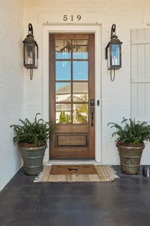 a view of staircase with a metal railing and a chandelier