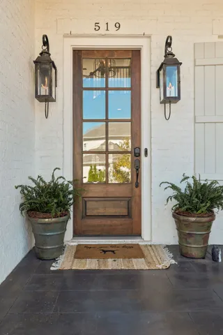 a view of staircase with a metal railing and a chandelier
