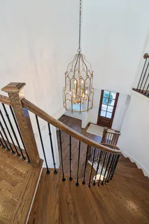 an aerial view of residential houses with outdoor space and parking