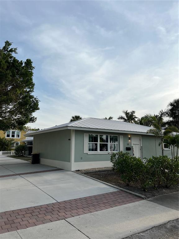 511 West Retta Esplanade Punta Gorda, FL 33950 - Photo 2 of 19 a front view of a house with a garden