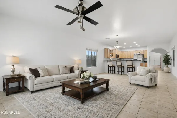a living room with furniture and a ceiling fan